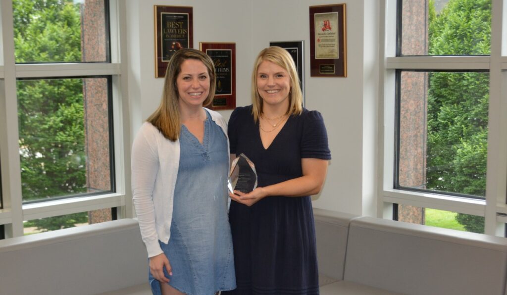 Colleen F. Molner and Hannah F. Little pose for a picture with a pro bono award.