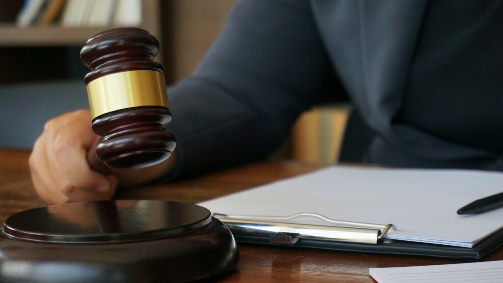 Close shot of a judge with a gavel and paperwork.