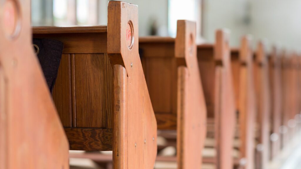 Close up of pews in a place of worship.